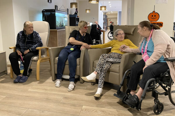 Le Progrès - un groupe de personnes âgées assises dans un fauteuil qui parlent - Maison de repos - La Louvière